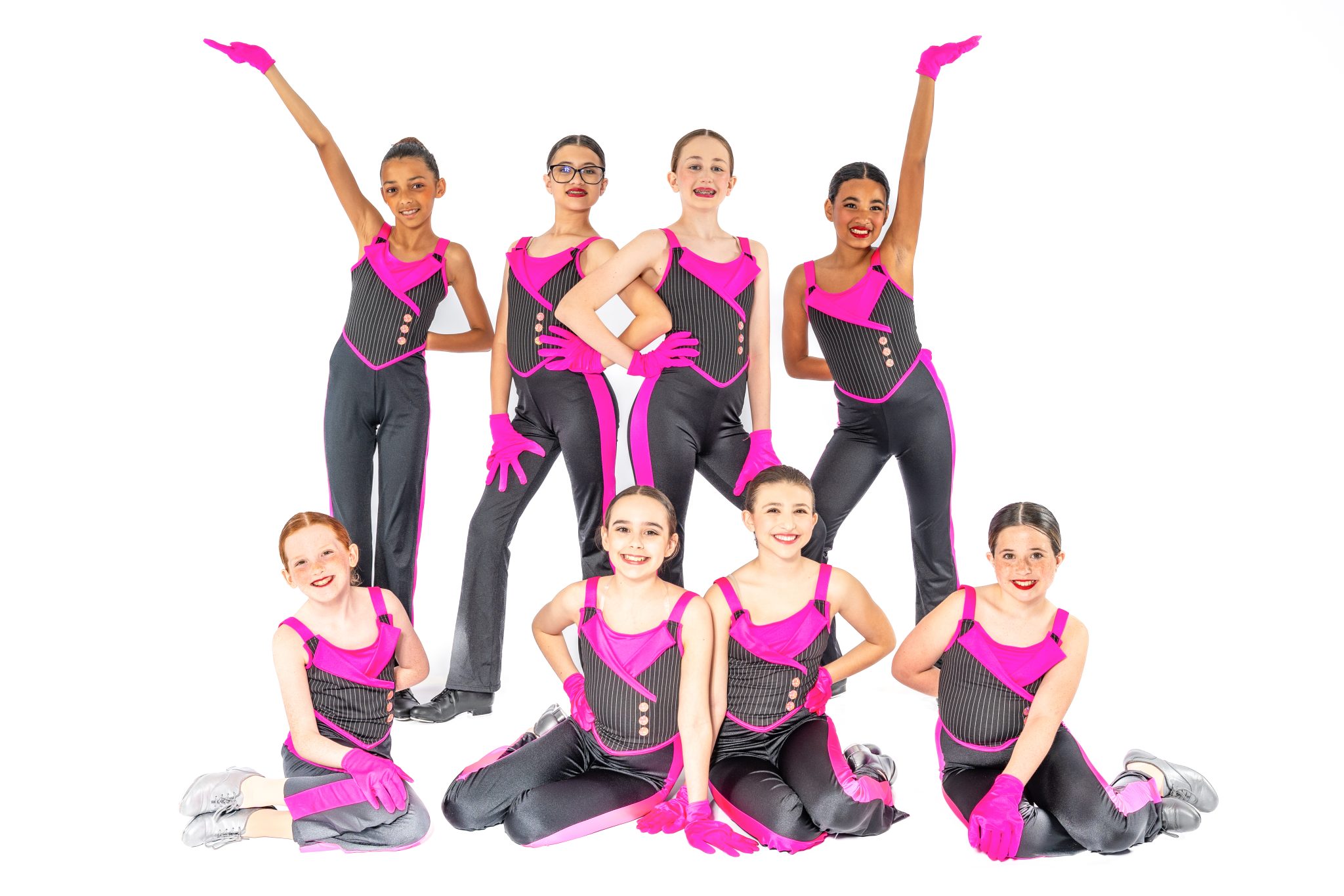 A group of Music in Motion dancers smiling together after class